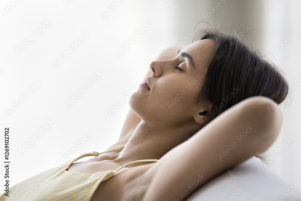 Moment of peace. Side view headshot portrait carefree beautiful teen girl sitting reclining on soft comfy sofa for peaceful rest breath deep with closed eyes relax in simple meditation dream nap alone Moment of peace. Side view headshot portrait carefree beautiful teen girl sitting reclining on soft comfy sofa for peaceful rest breath deep with closed eyes relax in simple meditation dream nap alone