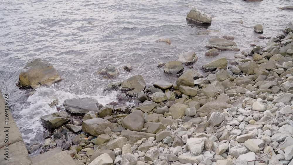 Peaceful ocean waves softly washing against weathered concrete pier, revealing serene coastal landscape with gentle water rhythms and natural marine textures Peaceful ocean waves softly washing against weathered concrete pier, revealing serene coastal landscape with gentle water rhythms and natural marine textures