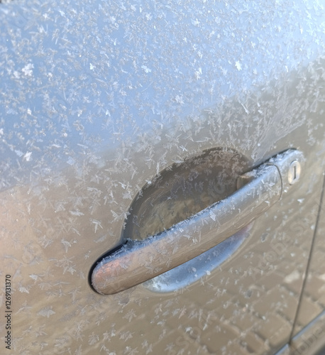 Frozen car handle covered in frost