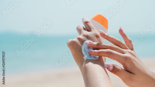 Health skin care, Young woman applying sunscreen cream on body, Sun Protection. Female hands with sun protection cream on sky background. Skin body cream moisturizing lotion
