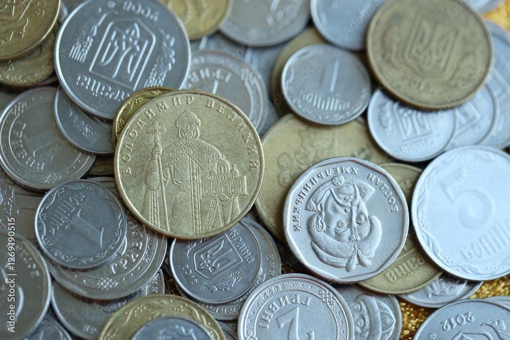 Metal coins of Ukraine of different denominations are scattered. Money texture, business background. Metal coins of Ukraine of different denominations are scattered. Money texture, business background.
