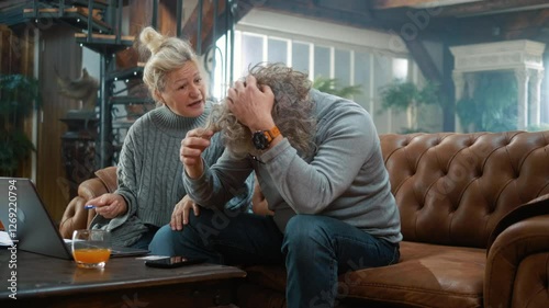 Annoyed elderly man is stressed due to insufficient money on the card for online payment, financial crisis, and upset retired couple at home with a laptop,  bankruptcy, and unpaid bills loan bank debt