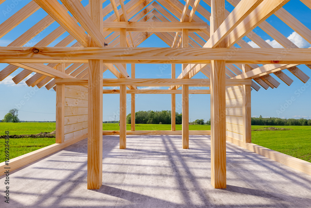 A wooden house frame under construction stands on a concrete foundation in a rural landscape. The exposed beams and roof structure highlight the early stages of building. 3d image A wooden house frame under construction stands on a concrete foundation in a rural landscape. The exposed beams and roof structure highlight the early stages of building. 3d image