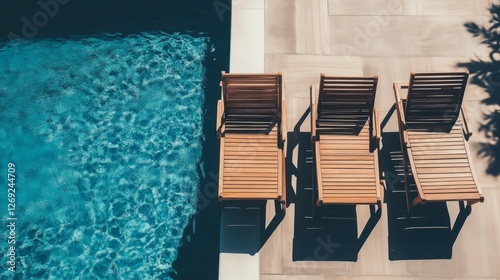 Beautiful shot of three sun loungers near the pool