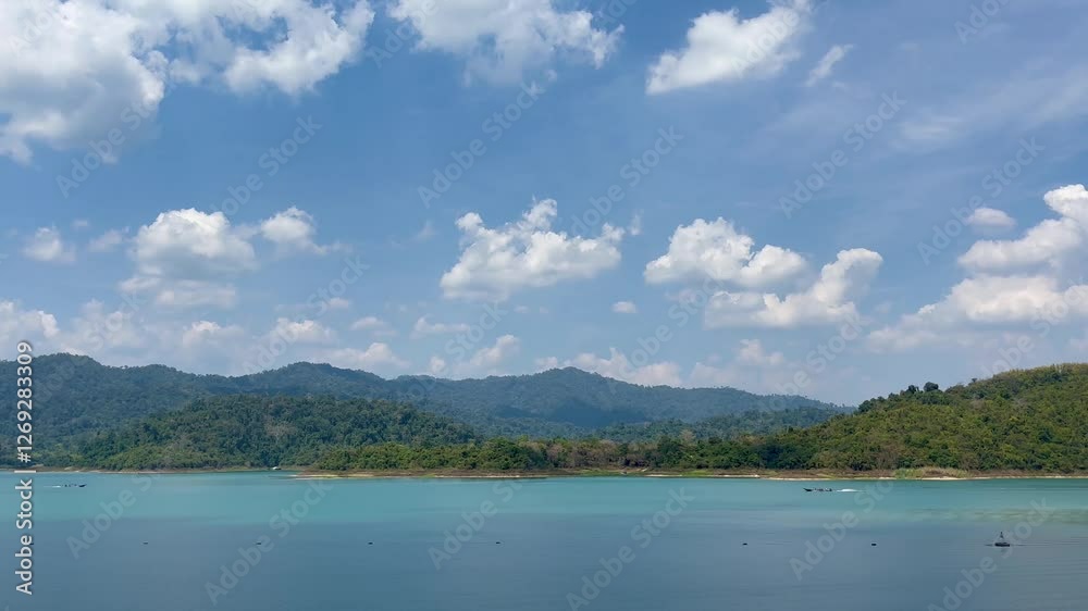 The stunning landscape of Cheow Lan Lake in Thailand features emerald-green waters, towering limestone cliffs, and lush rainforest, creating a scene of pure tranquility and natural wonder. The stunning landscape of Cheow Lan Lake in Thailand features emerald-green waters, towering limestone cliffs, and lush rainforest, creating a scene of pure tranquility and natural wonder.