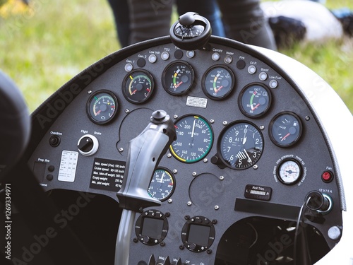 Canvas Print A detailed view of an ultralight aircraft cockpit showing various flight instruments, gauges, and controls