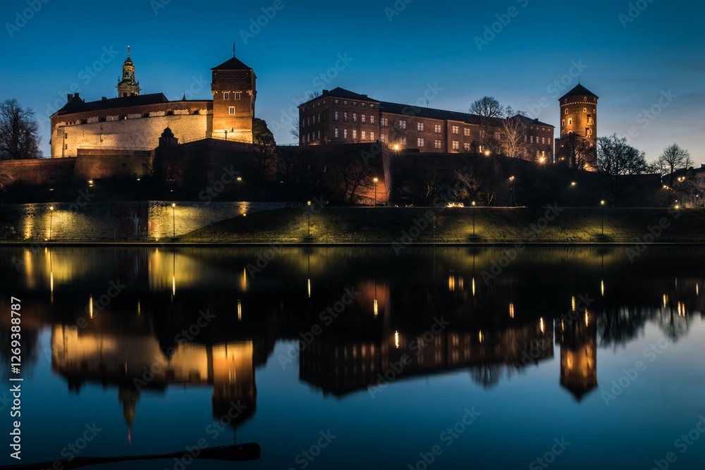 Fototapeta premium Poland, Krakow: Royal Castle of Wawel by morning blue hour with reflection in water