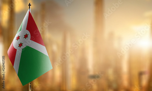 Small flags of the Burundi on an abstract blurry background photo