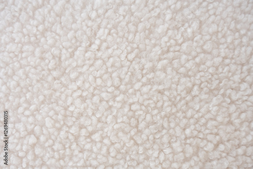 Detailed close-up of plush white sherpa fleece fabric with a wavy, curly pattern