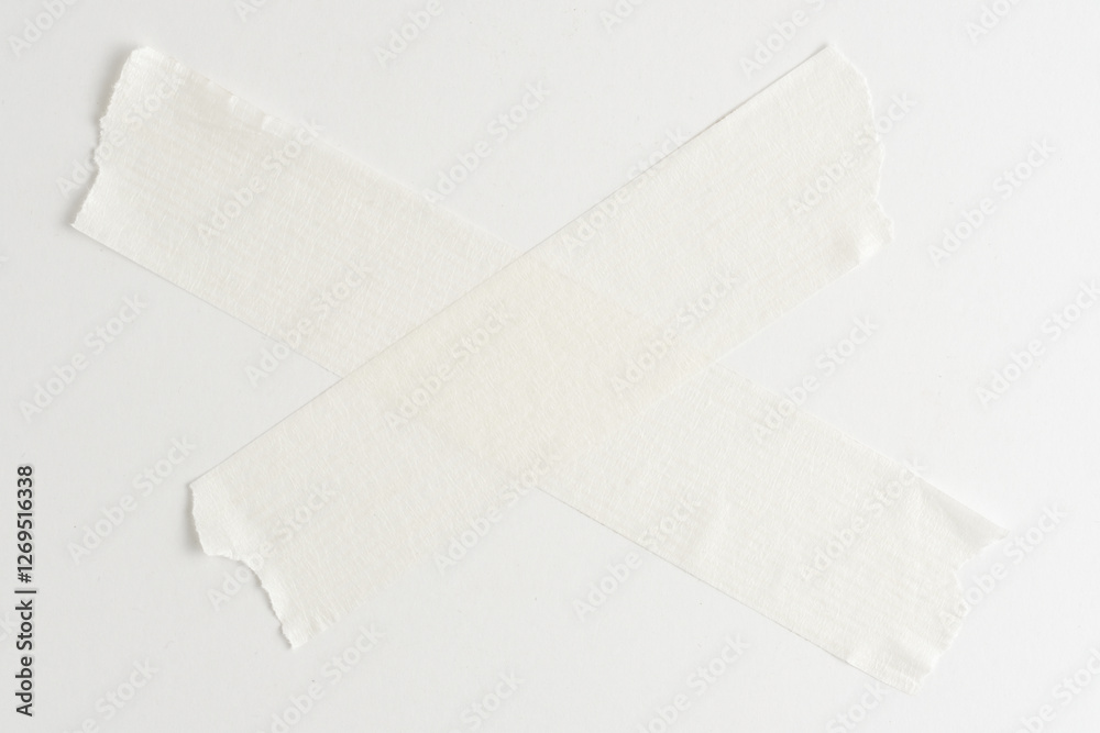 White masking tape in form of cross on white background with place for copying text. White masking tape in form of cross on white background with place for copying text.