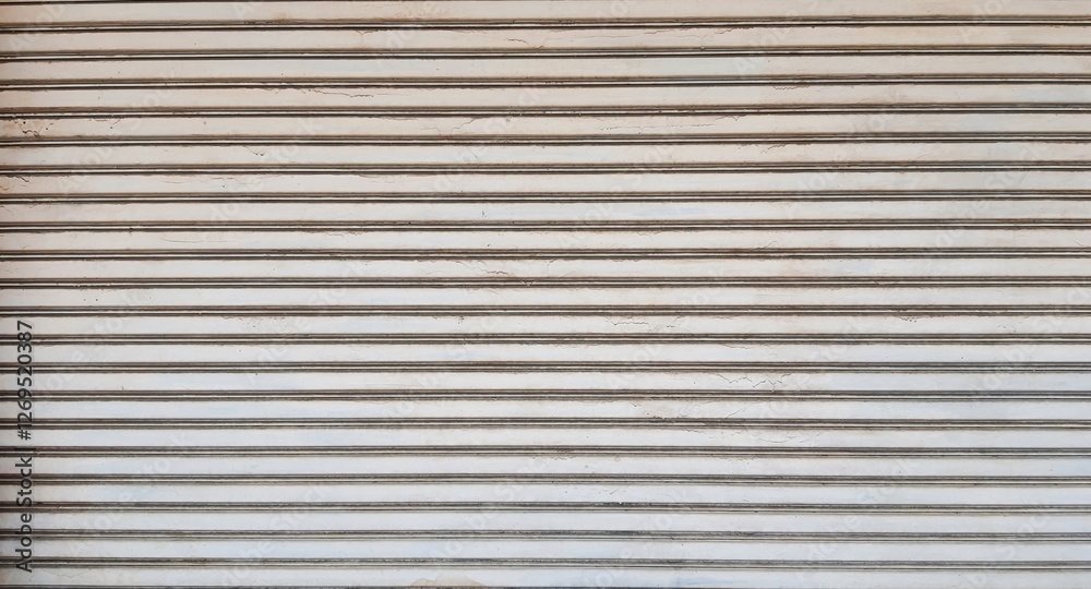 Rolling door. Steel shutter door of warehouse. The shutters are gray metal. Steel rolling shutter background. Silver metal rolling shutter background. Background images and texture images. Rolling door. Steel shutter door of warehouse. The shutters are gray metal. Steel rolling shutter background. Silver metal rolling shutter background. Background images and texture images.