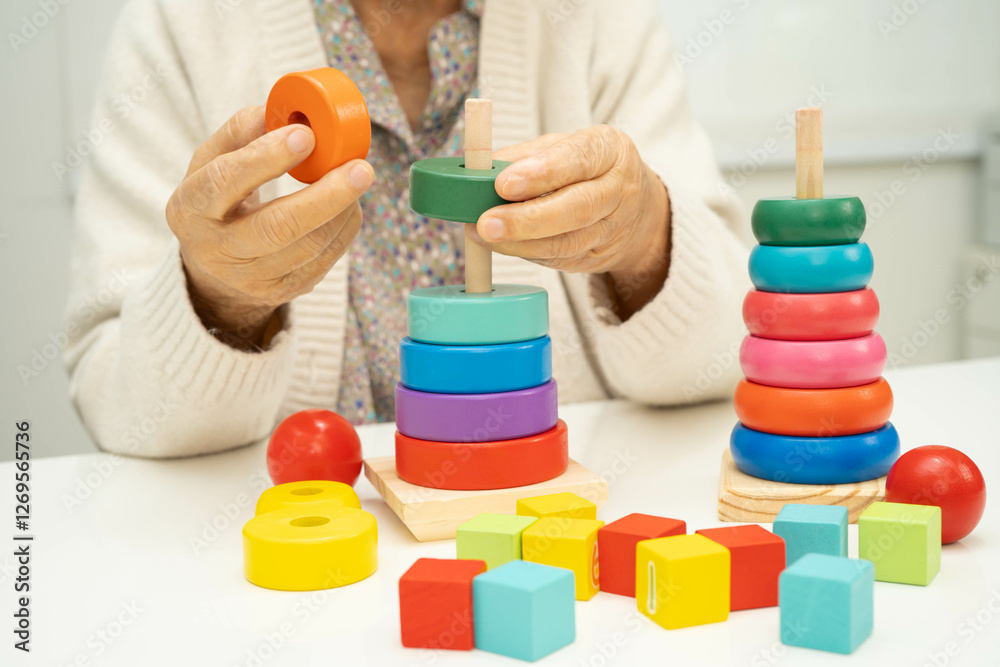 Asian elderly woman playing enhancing skill board game. Asian elderly woman playing enhancing skill board game.