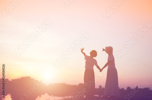 a silhouette of a happy young girl child the arms of his loving