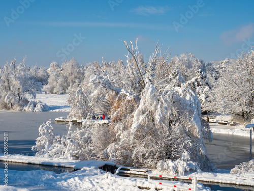 Zurich, Switzerland - December 12th 2023: Irchelpark in winter conditions with frozen lake and deep snow