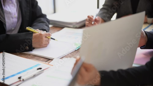 Small group of businessmen starting company, planning creative meeting using digital tablet showing financial data and graphs and laptop, financial analysis.