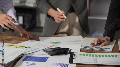 Small group of businessmen starting company, planning creative meeting using digital tablet showing financial data and graphs and laptop, financial analysis.