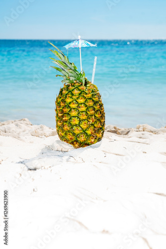 Beautiful pineapple cocktail against the backdroo of the Caribbean sea photo