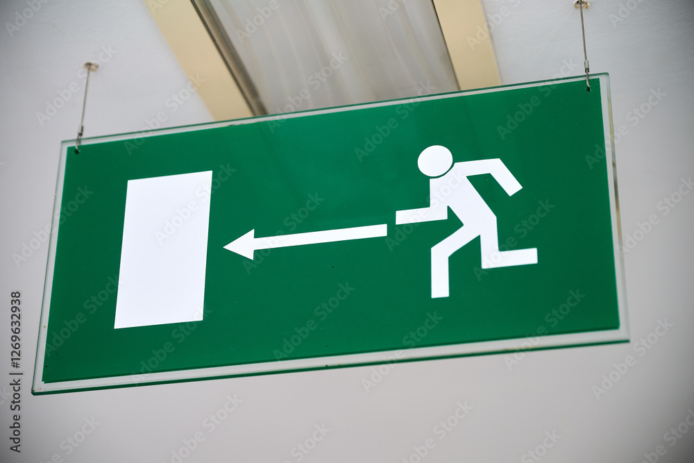 Green emergency sign indicate the right direction hanging Green emergency sign indicate the right direction hanging