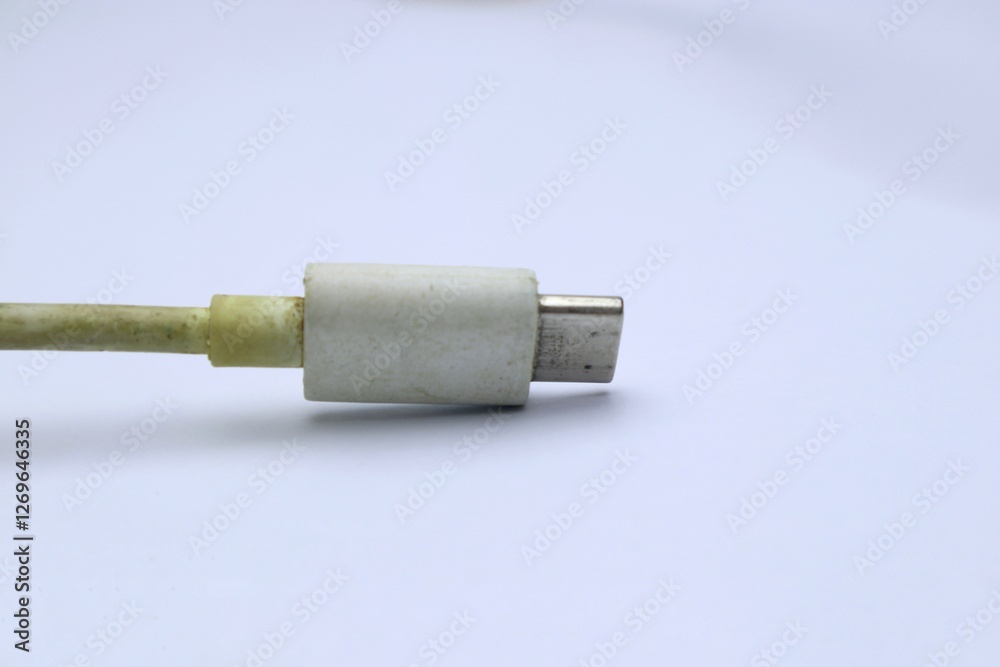 Close up of a dirty and stained USB-C cable connector on white background Close up of a dirty and stained USB-C cable connector on white background