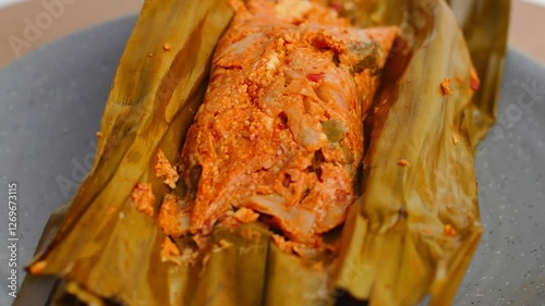 Mushrooms with spices wrapped in banana leaves become mushroom pepes. Traditional Indonesian food in the form of mushroom pepes and tofu wrapped together in banana leaves. mushroom sauce. photo