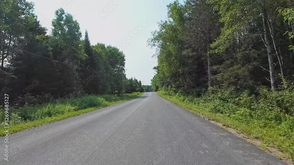 Empty highway freeway front driver plate at the Burk's Falls, Pickerel Lake, during hot July summer. Driving motorhome caravan car for vacation and adventure in the Canadian cottage countryside.