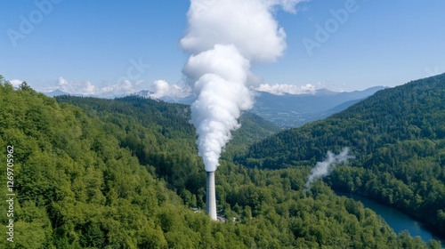 Tower Emitting White Steam Among Lush Green Forest Mountains