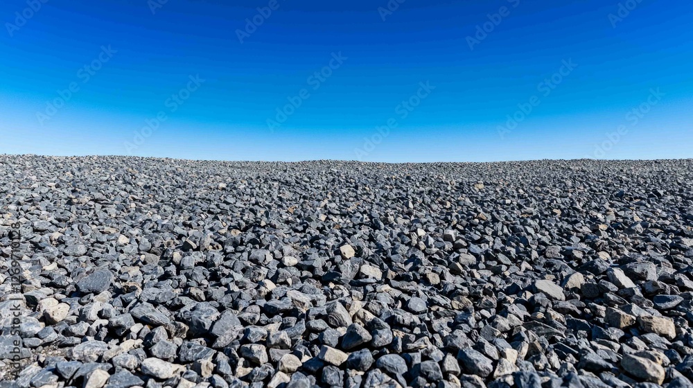 Vast Panoramic View of a Gravel Field Against a Clear Sky Vast Panoramic View of a Gravel Field Against a Clear Sky