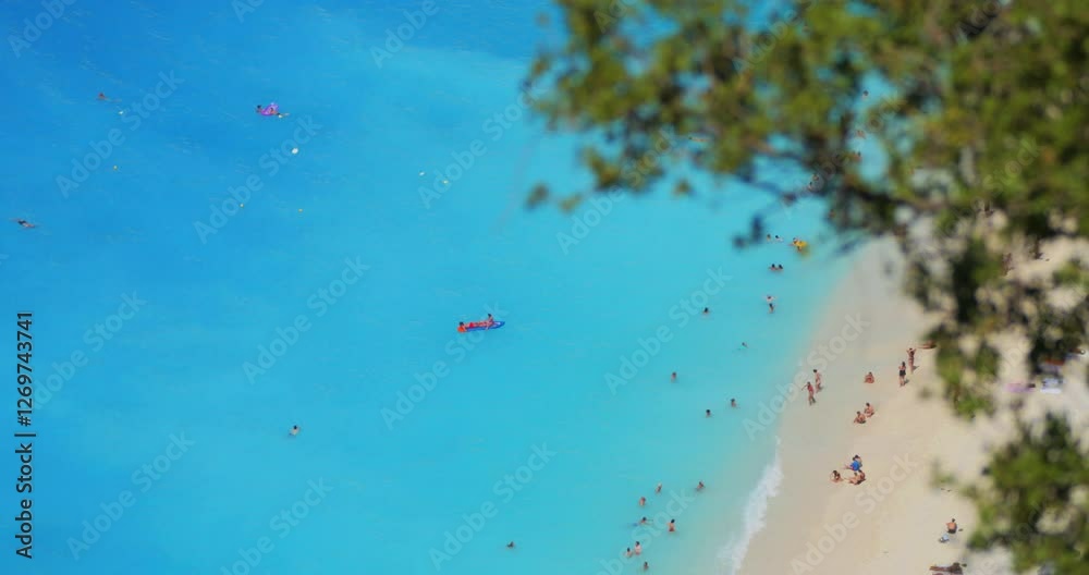 Top view detail of tourists on Myrtos beach in Kefalonia island, Greece Top view detail of tourists on Myrtos beach in Kefalonia island, Greece