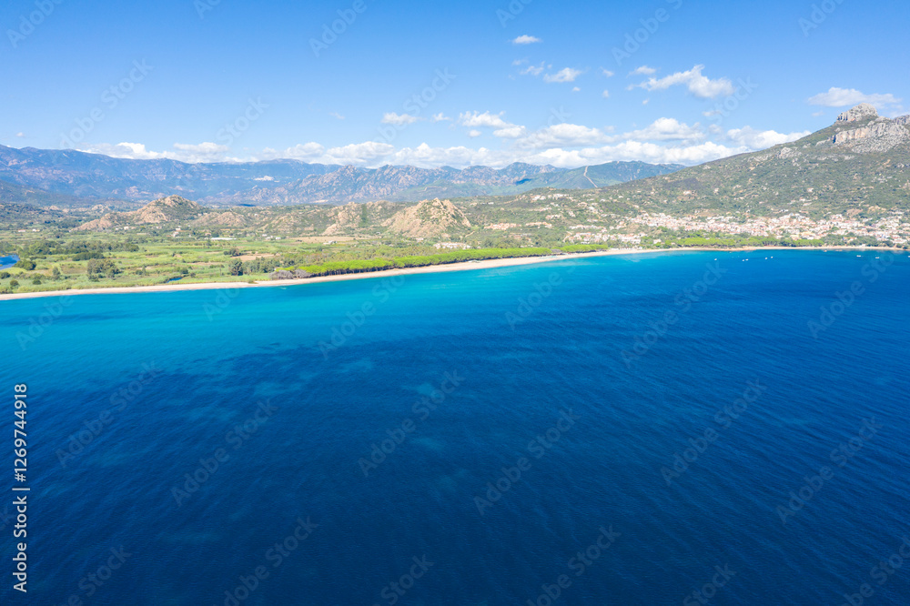 Fototapeta premium The coast seen from the sea in Lotzorai in Europe, Italy, Sardinia, Lotzorai, in summer, on a sunny day.
