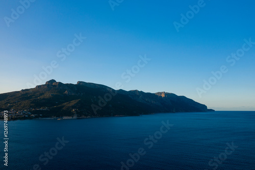 The cliffs by the sea in Lotzorai in Europe, Italy, Sardinia, Lotzorai, in summer, on a sunny day.