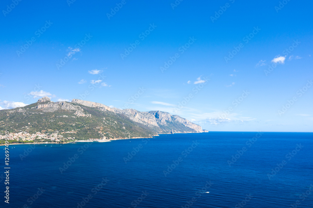 The cliffs by the sea in Lotzorai in Europe, Italy, Sardinia, Lotzorai, in summer, on a sunny day. The cliffs by the sea in Lotzorai in Europe, Italy, Sardinia, Lotzorai, in summer, on a sunny day.