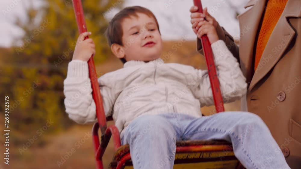 Mother swings son on swing in park. Mother swings son on swing amid scenery sharing moment in park. Mother swings son on swing in park enjoys moments creating experience in midst of beauty of season Mother swings son on swing in park. Mother swings son on swing amid scenery sharing moment in park. Mother swings son on swing in park enjoys moments creating experience in midst of beauty of season