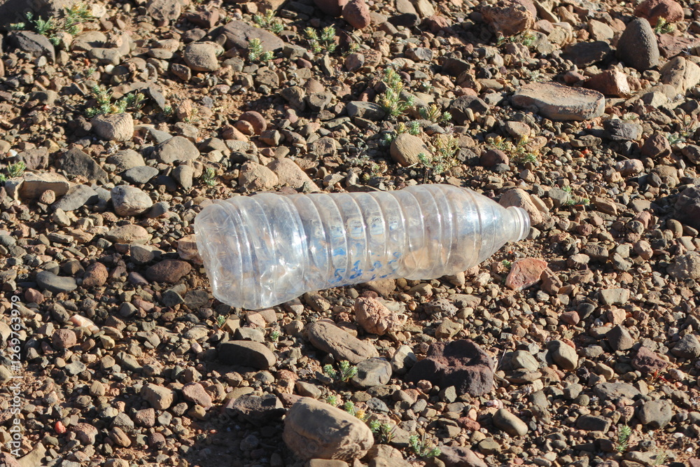 Empty plastic bottle lying on ground Empty plastic bottle lying on ground