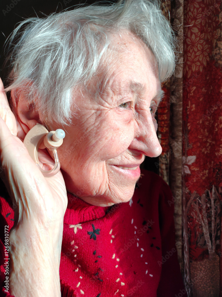 Middle age woman smiling confident using hearing aid