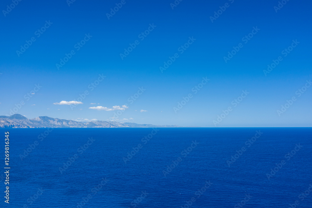 The Mediterranean Sea towards Cala Goloritze beach in Baunei in Europe, Italy, Sardinia, Baunei, in summer, on a sunny day. The Mediterranean Sea towards Cala Goloritze beach in Baunei in Europe, Italy, Sardinia, Baunei, in summer, on a sunny day.