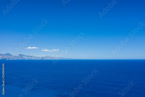 The Mediterranean Sea towards Cala Goloritze beach in Baunei in Europe, Italy, Sardinia, Baunei, in summer, on a sunny day.