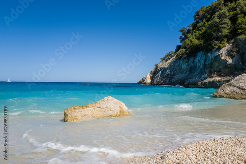 Fototapeta Naklejka Na Ścianę i Meble -  The rocks of Cala Goloritze beach in Baunei in Europe, Italy, Sardinia, Baunei, in summer, on a sunny day.