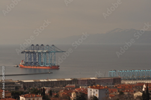 Rijeka, Croatia 17.02.2025. Ship transporting new crain's for Rijeka container terminal. Crain's were deported from China during 70 days of sailing to Rijeka harbour in Europe photo