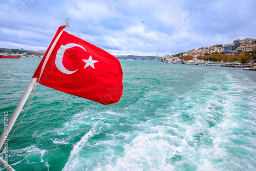 Turkish flag on the boat cruising Bosphorus channel in Istanbul
