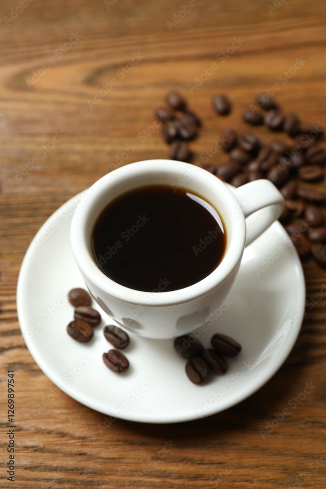 Cup of coffee and fresh coffee beans on wooden background Cup of coffee and fresh coffee beans on wooden background