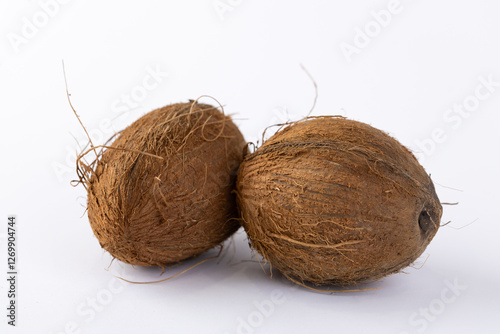 Two Unique Dried Fruits with Natural Fibers and Earthy Exterior Contextualized Amidst a White Background for Pure Aesthetic Appeal and Clarity of Details and Texture photo