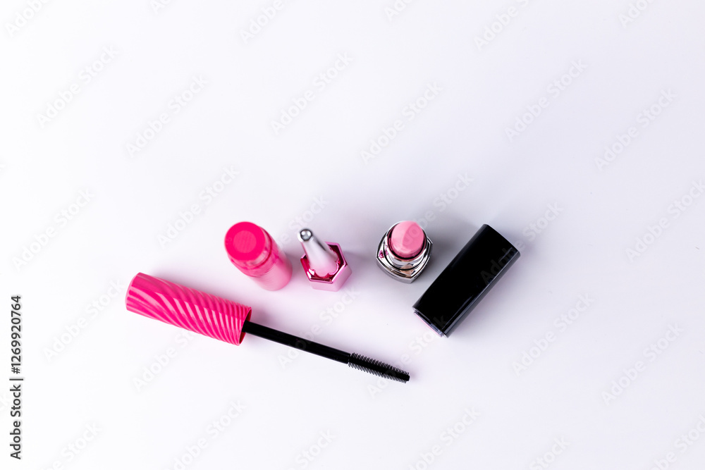 An Array of Vibrant Makeup Essentials Displayed on a Smooth White Surface Featuring a Mascara, Lipsticks, and a Glossy Lip Product for Beauty Enthusiasts An Array of Vibrant Makeup Essentials Displayed on a Smooth White Surface Featuring a Mascara, Lipsticks, and a Glossy Lip Product for Beauty Enthusiasts