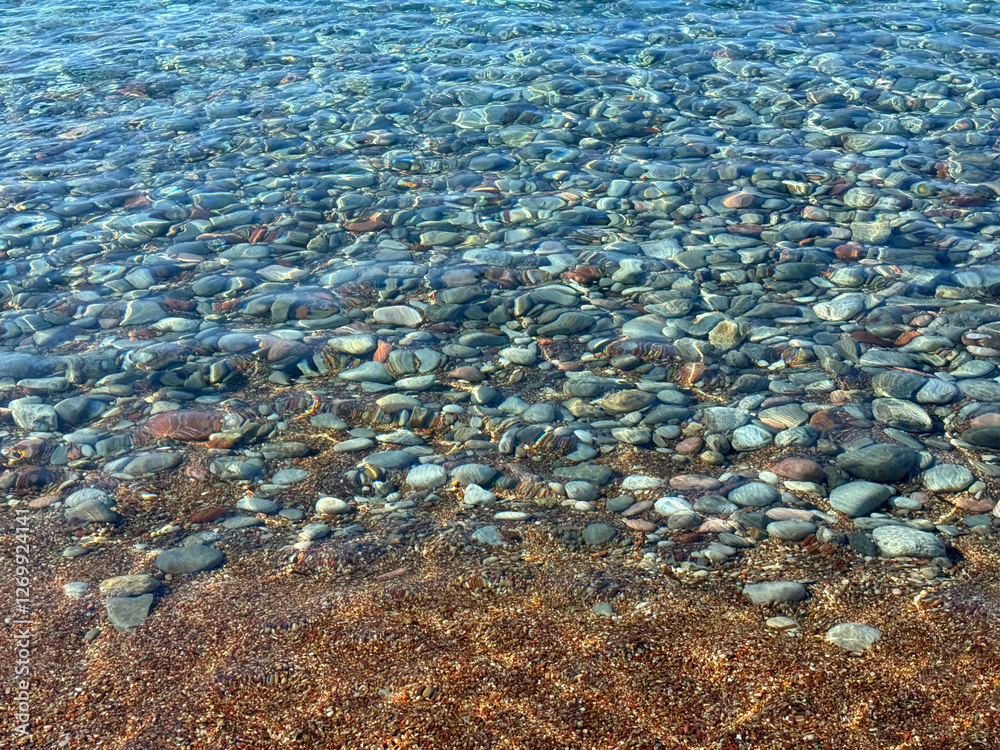 Clear sea on pebbles beach.