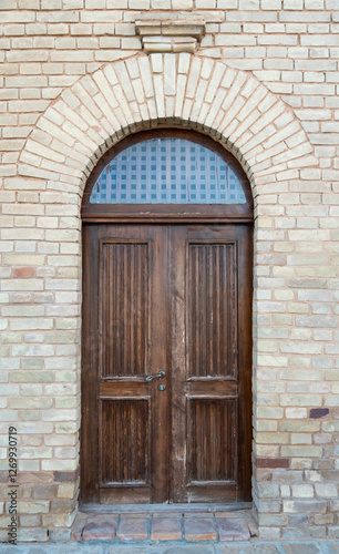 Historical old door in brick wall