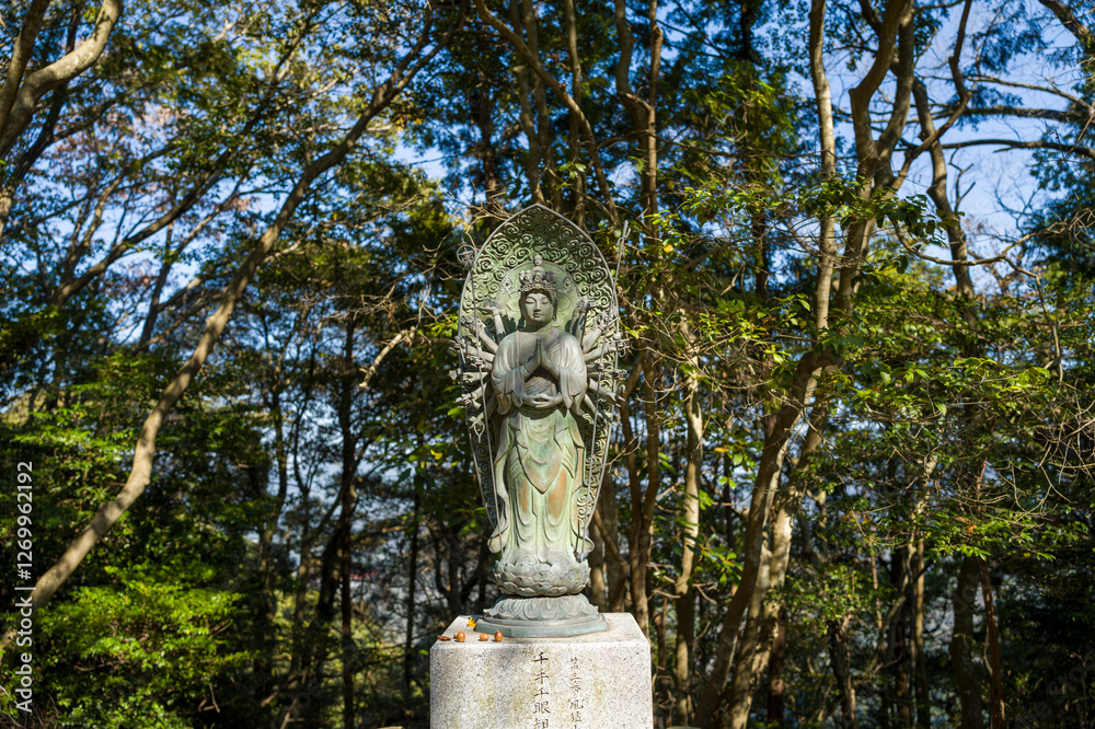 The statue on the path around the Engyoji Maniden in Himeji in Asia, Japan, Kansai, Himeji, in summer, on a sunny day. The statue on the path around the Engyoji Maniden in Himeji in Asia, Japan, Kansai, Himeji, in summer, on a sunny day.
