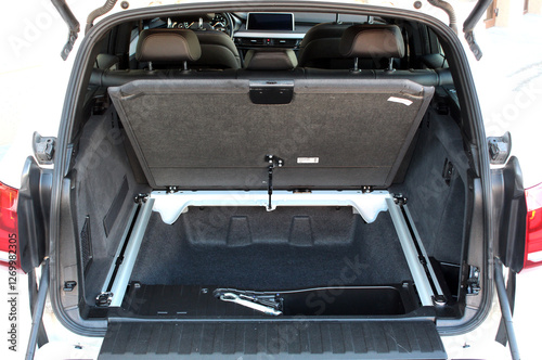 Boot Double Floor Compartment modern car. Double Layer Trunk. Double compartment in trunk of car. Raised first floor of the trunk of car. A raised partition that divides car boot floor into two parts.