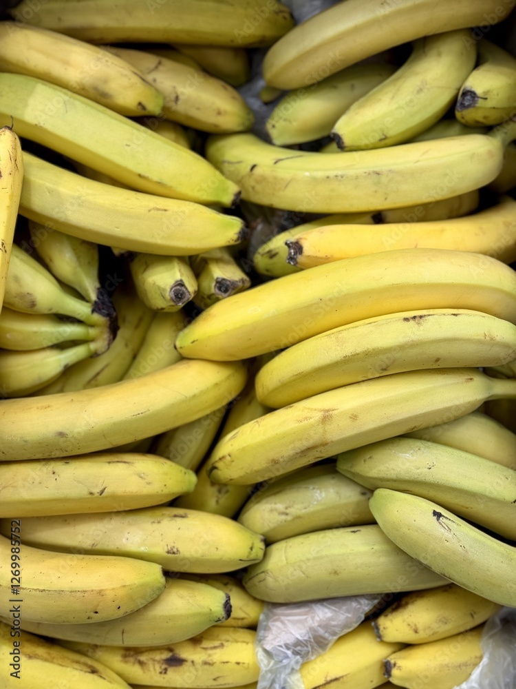 Ripe juicy yellow bananas close-up on a shelf in a supermarket. Close-up