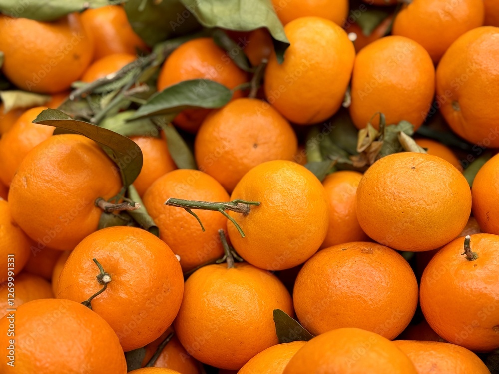 Box with ripe fresh organic tangerines on the shelf of a fruit supermarket are displayed for sale Box with ripe fresh organic tangerines on the shelf of a fruit supermarket are displayed for sale