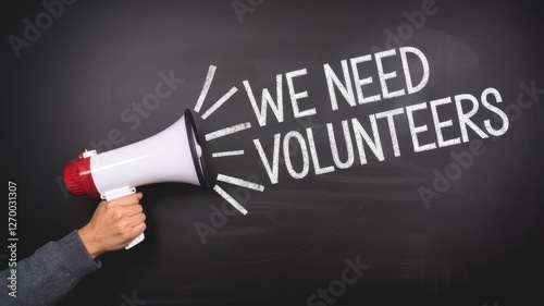 Hand holding megaphone announces the urgent need for volunteers
