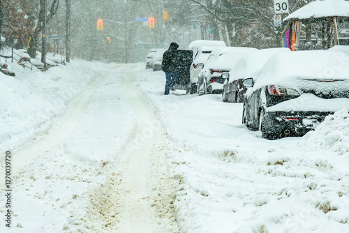Photography time to dig out: snow covered cars parked on snow choked residential street afte